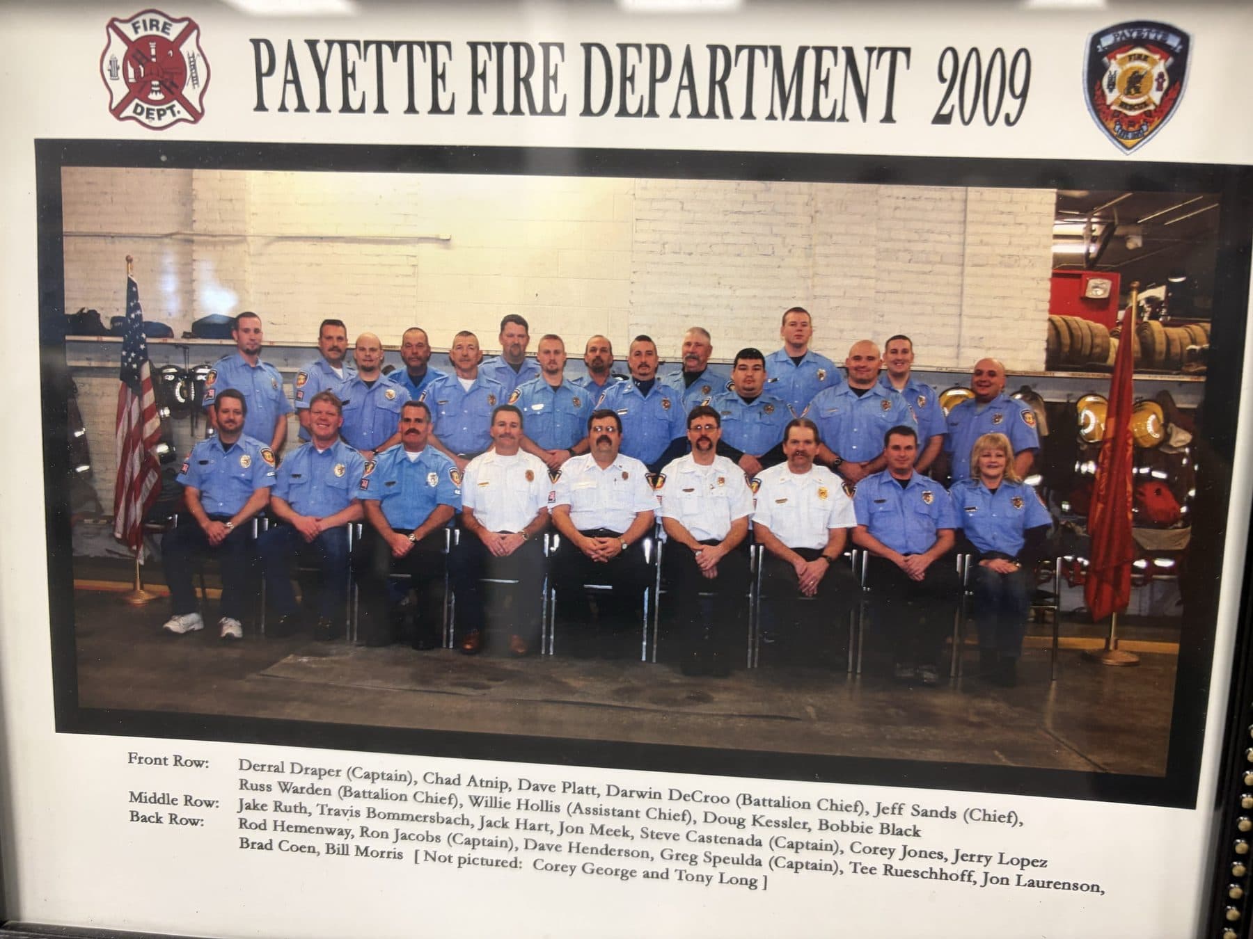 Payette Fire Department 2009 crew photo in blue uniforms inside the apparatus bay with an American flag