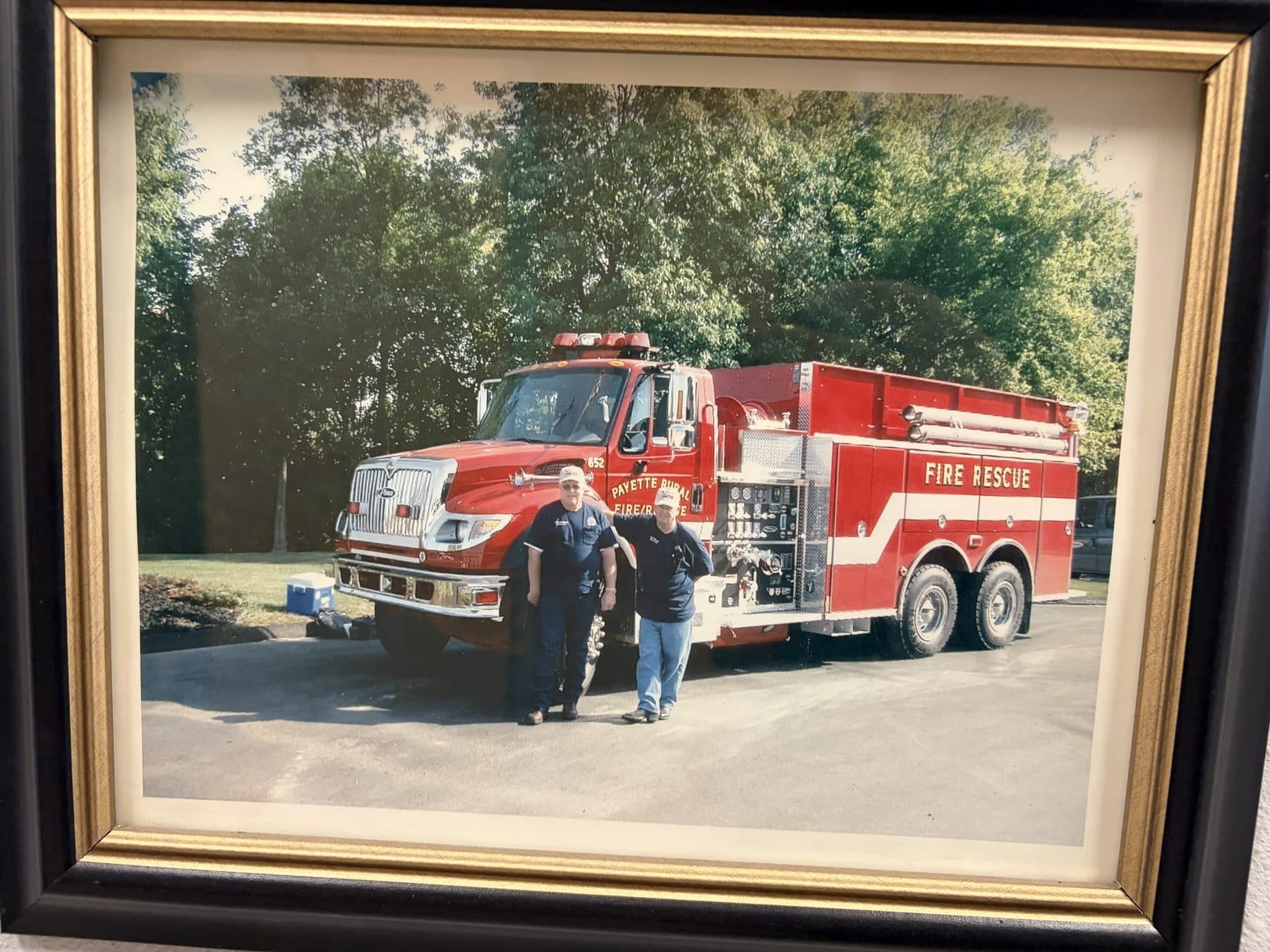 Payette Rural Fire Rescue tender 652 parked outside with two firefighters standing in front of it
