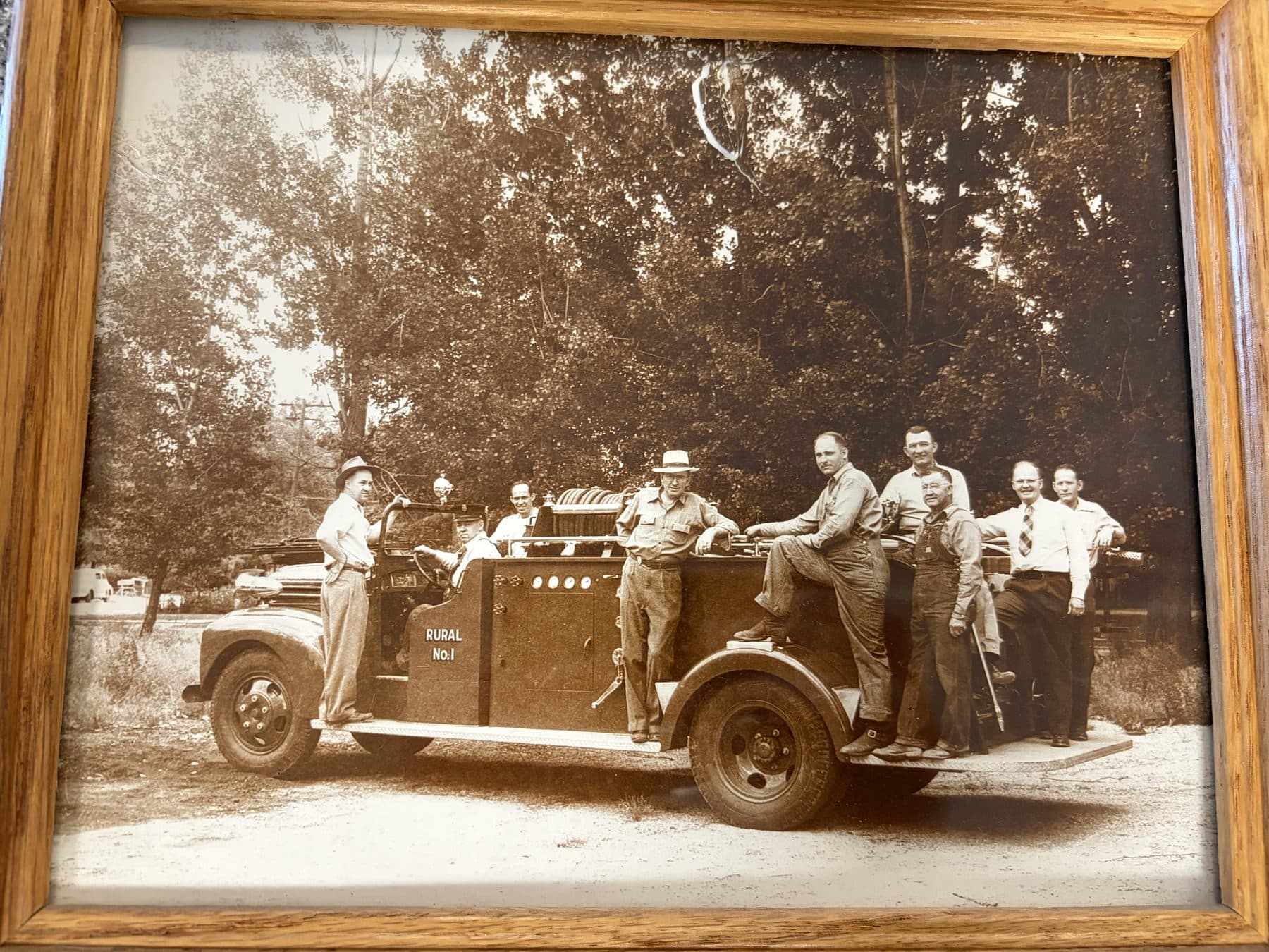 Sepia photograph of the Payette Rural No. 1 fire truck with crew members standing on and around it