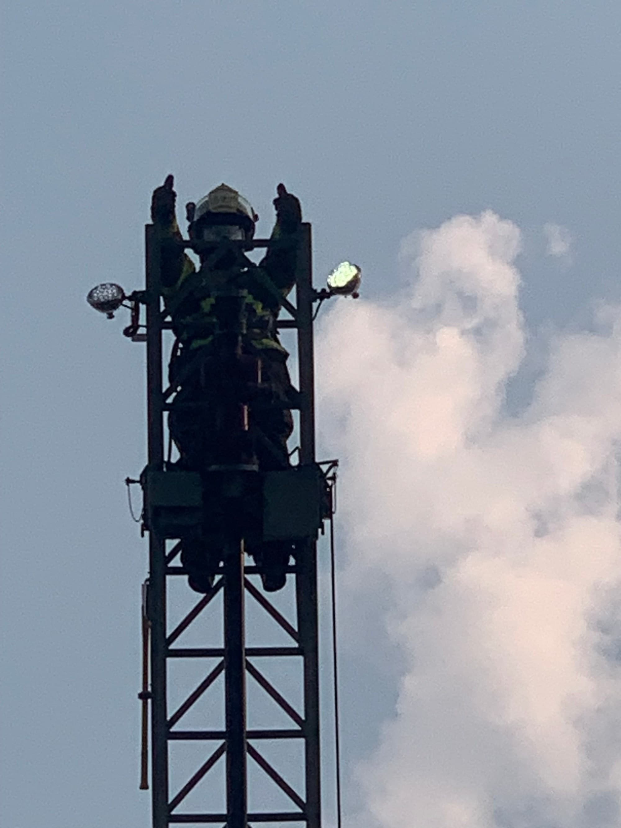 A Payette ladder truck with its aerial raised against a blue sky