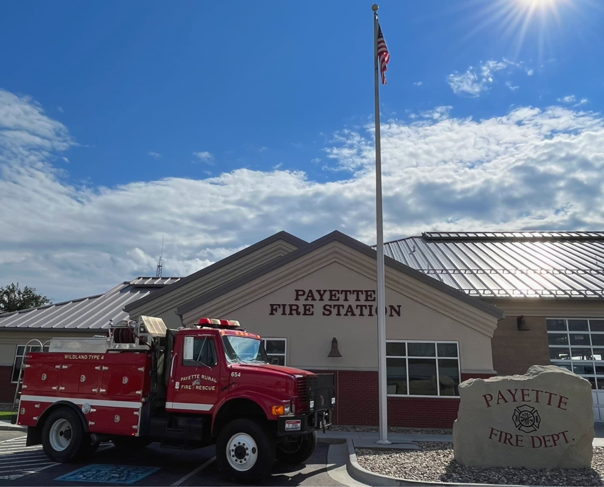 The Payette Fire Station beneath a clear Idaho sky, flag flying out front