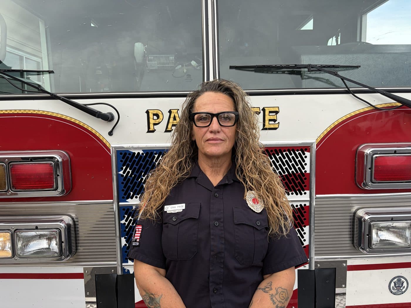 Fire Captain and EMT Gina Page in uniform, standing in front of a Payette fire engine.